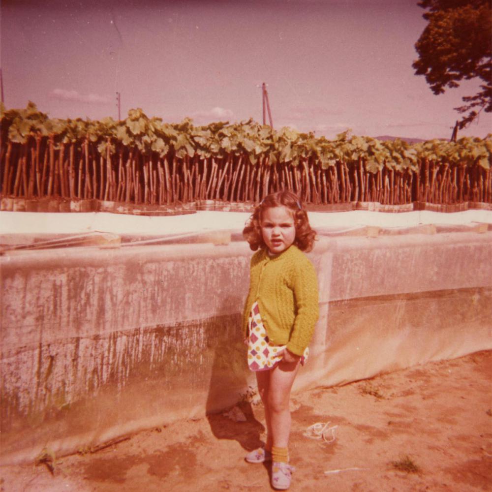 Rachel à côté des plants de vignes en pot